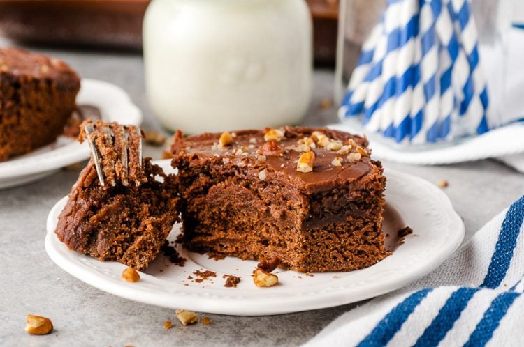 Slice of buttermilk chocolate cake with a bite taken out of it.