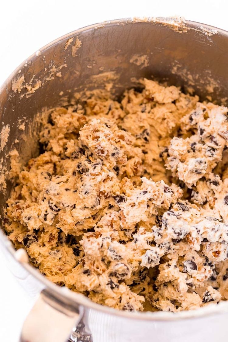 Chocolate chip cookie dough in a stand mixer bowl.