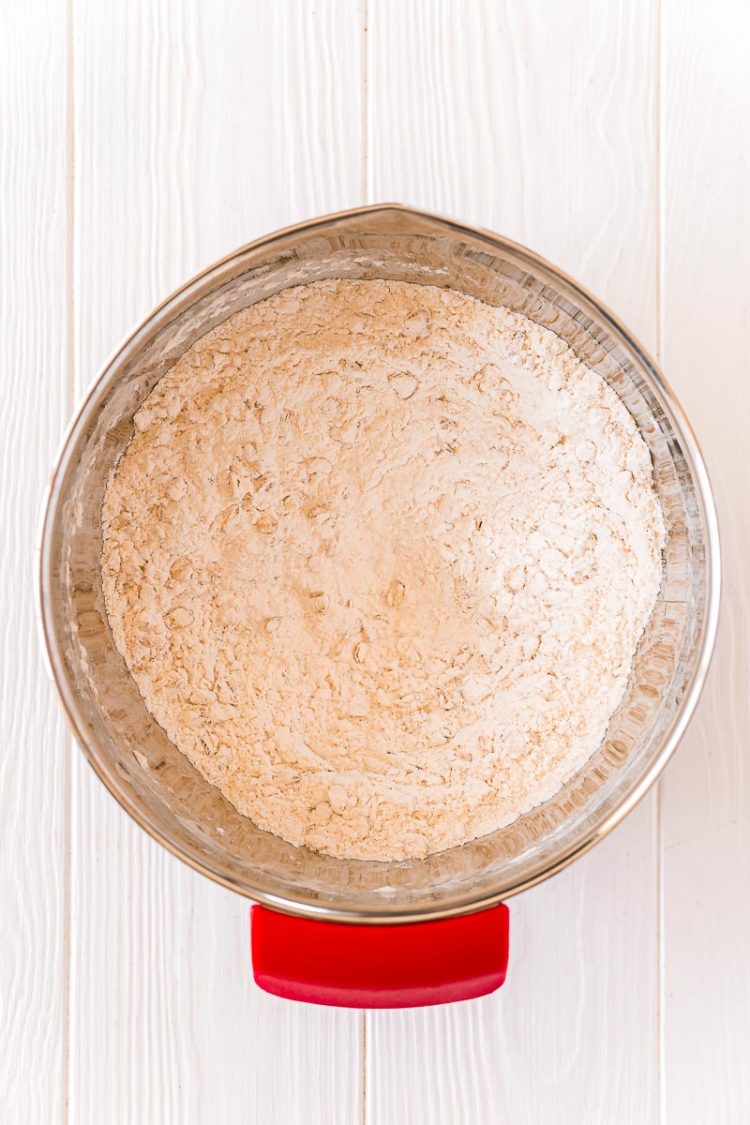 Dry ingredients to make cookies mixed together in a stainless steel mixing bowl.