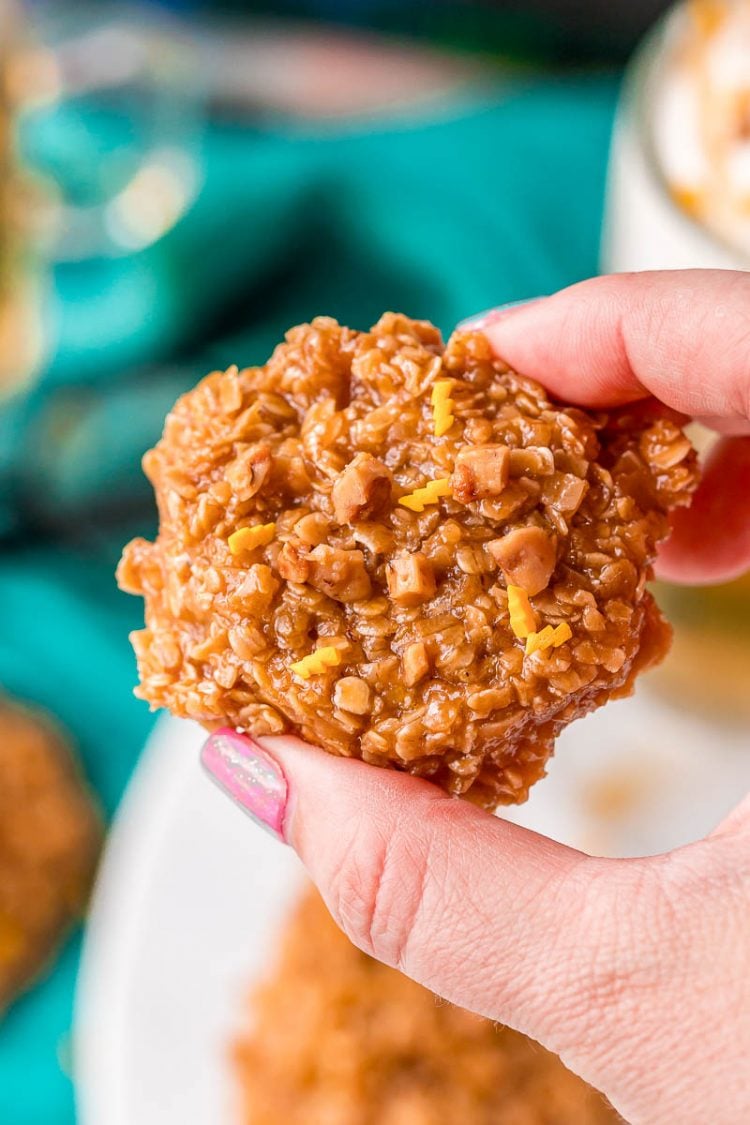 Woman's hand holding a butterscotch no bake cookie.