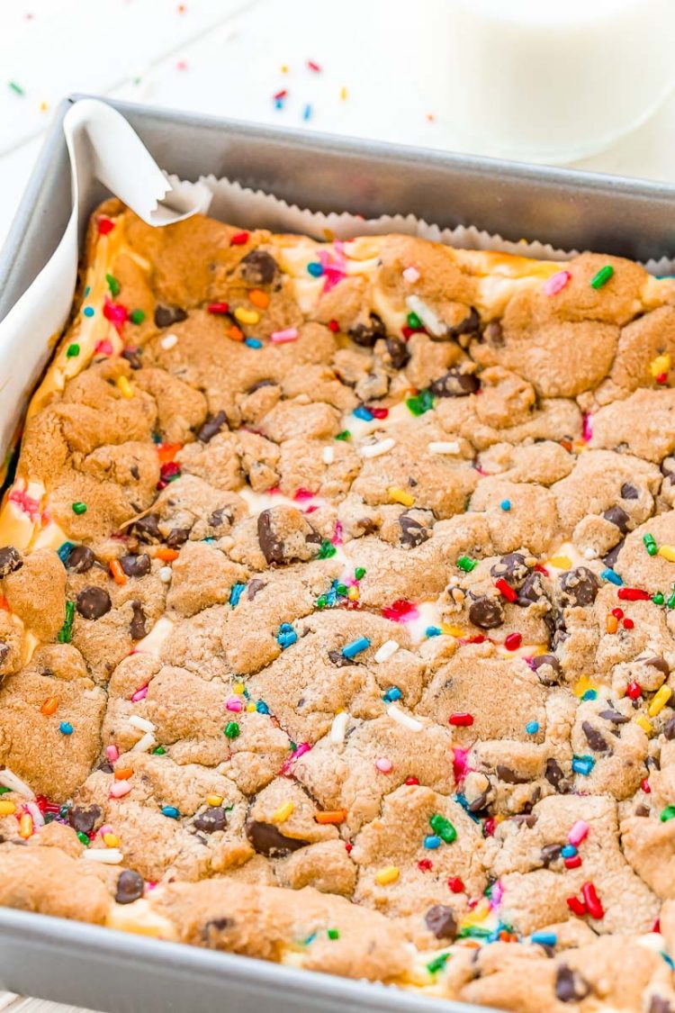 Chocolate chip cheesecake bars in a metal baking pan.