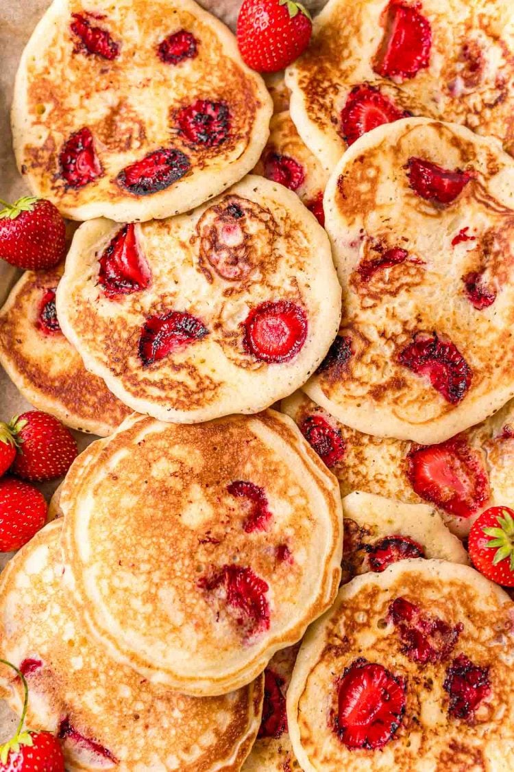Overhead photo of a baking sheet with strawberry pancakes on it.