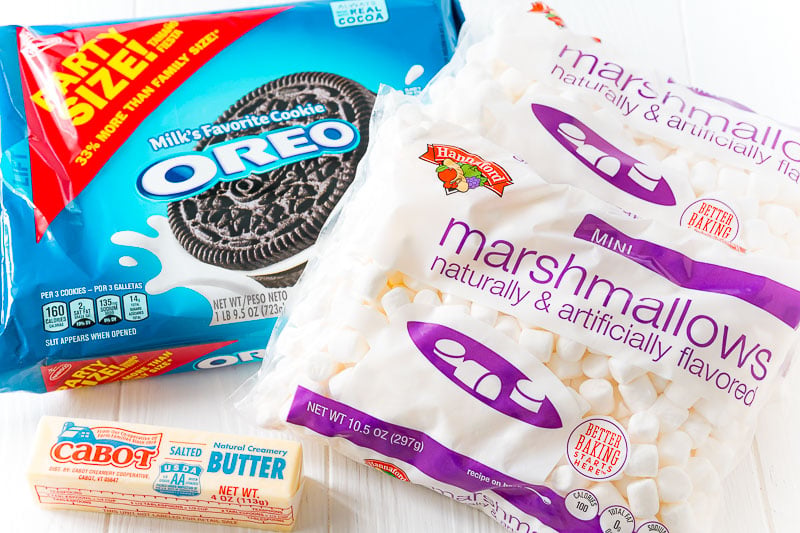 ingredients to make marshmallow oreo treats on a white table.