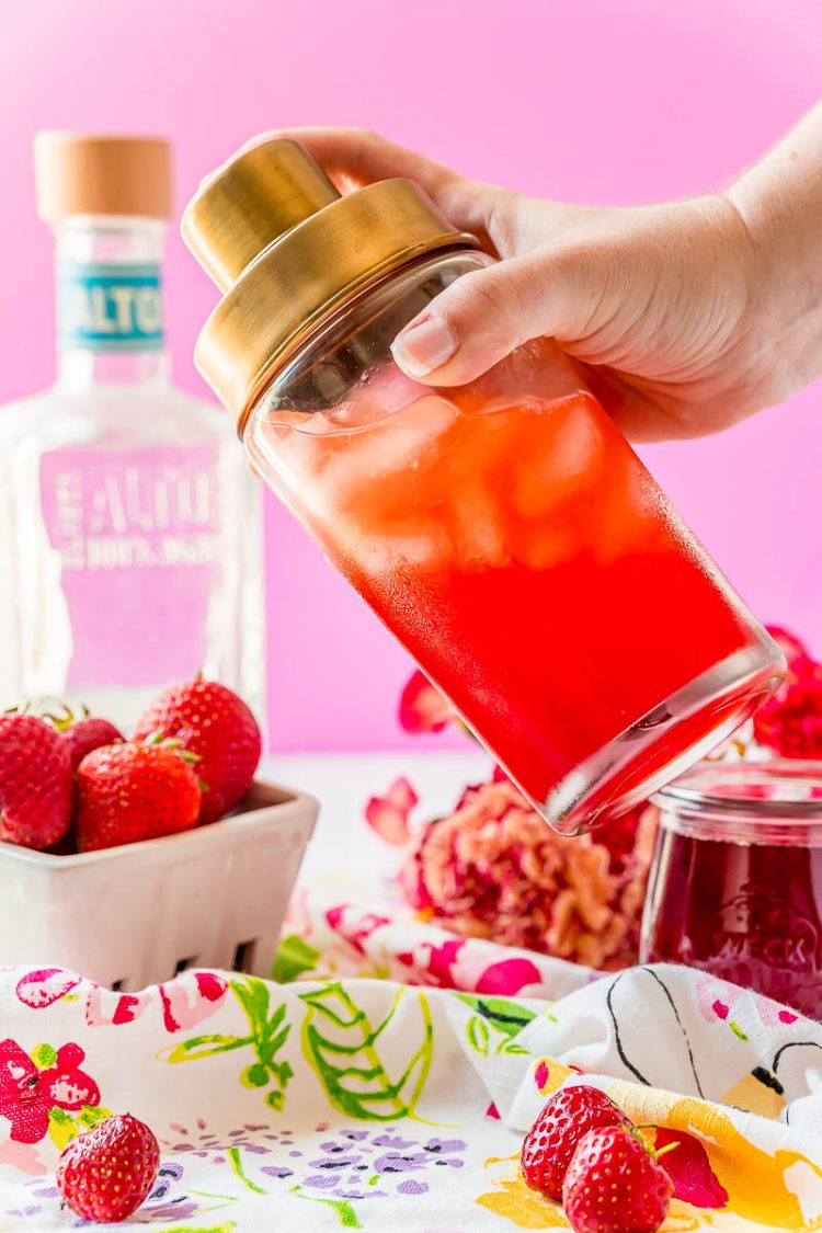 Strawberry margarita being shaken in a cocktail shaker.