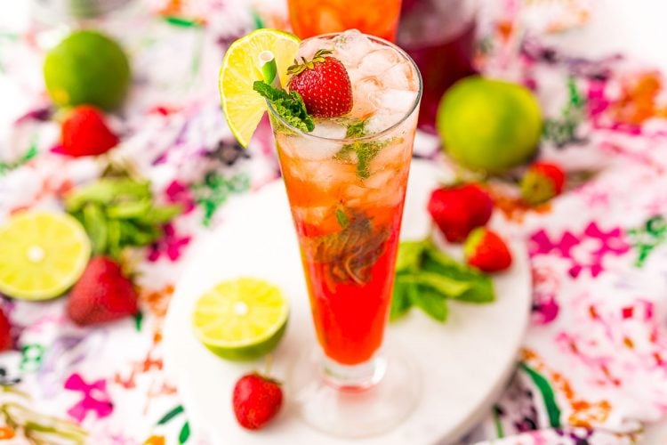Wide photo of  cocktail glass filled with strawberry mojito.