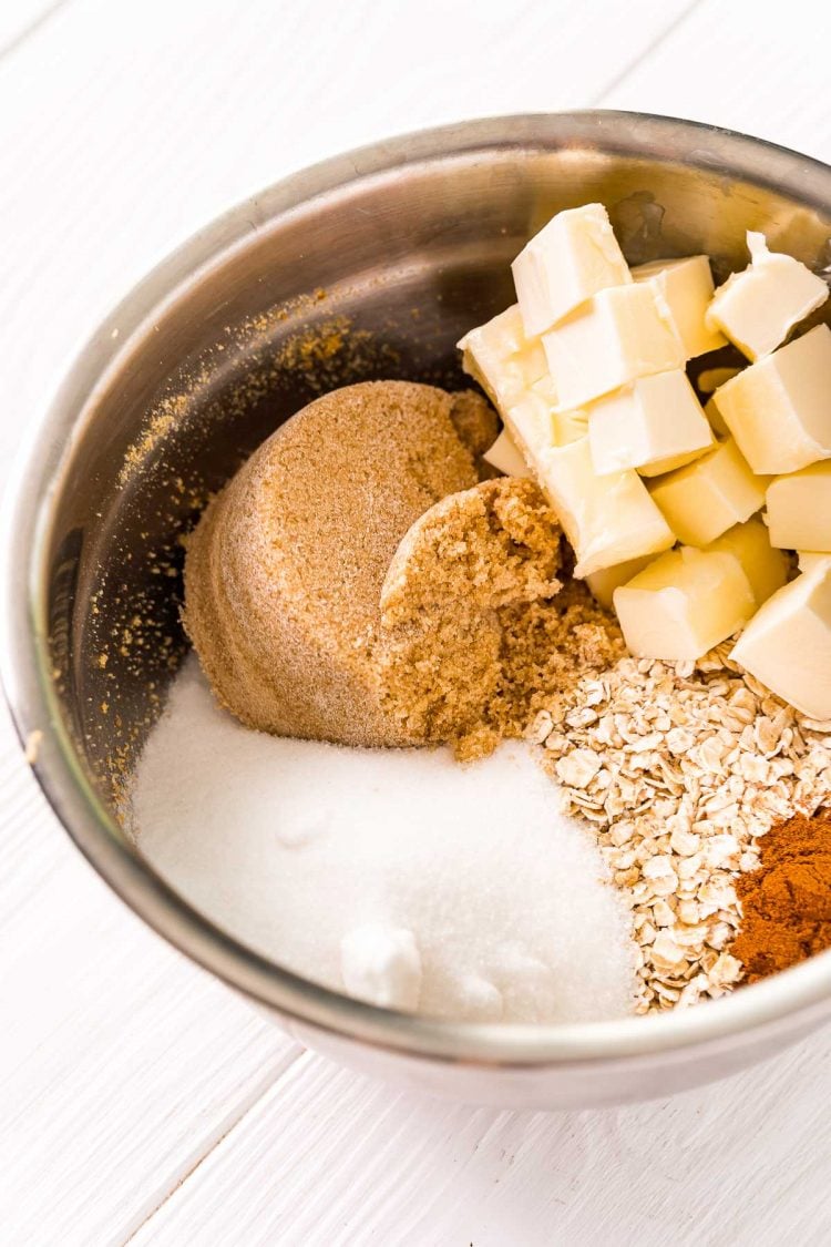 Ingredients to make a crumble topping in a metal mixing bowl.