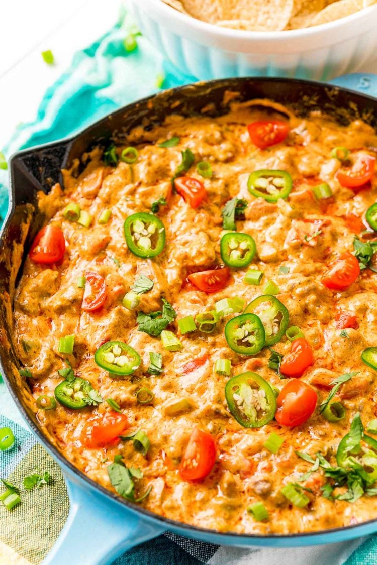 Cheesey sausage dip in a cast iron pan.