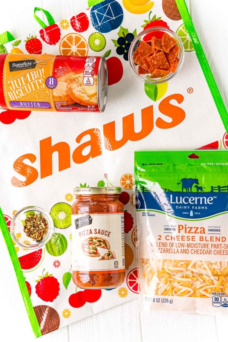 Ingredients to make mini pizzas on a shaws reusable bag.