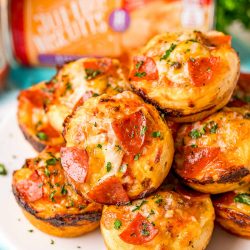 Close up photo of mini pizzas on a plate.