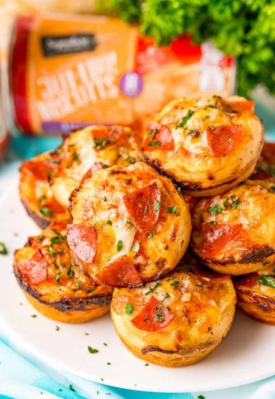 Close up photo of mini pizzas on a plate.