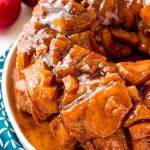 Apple monkey bread on a white plate on a blue napkin.