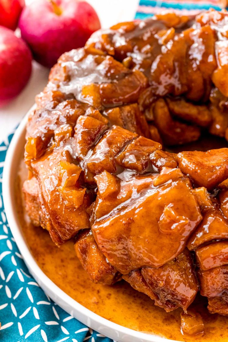 Apple monkey bread on a white plate on a blue napkin.