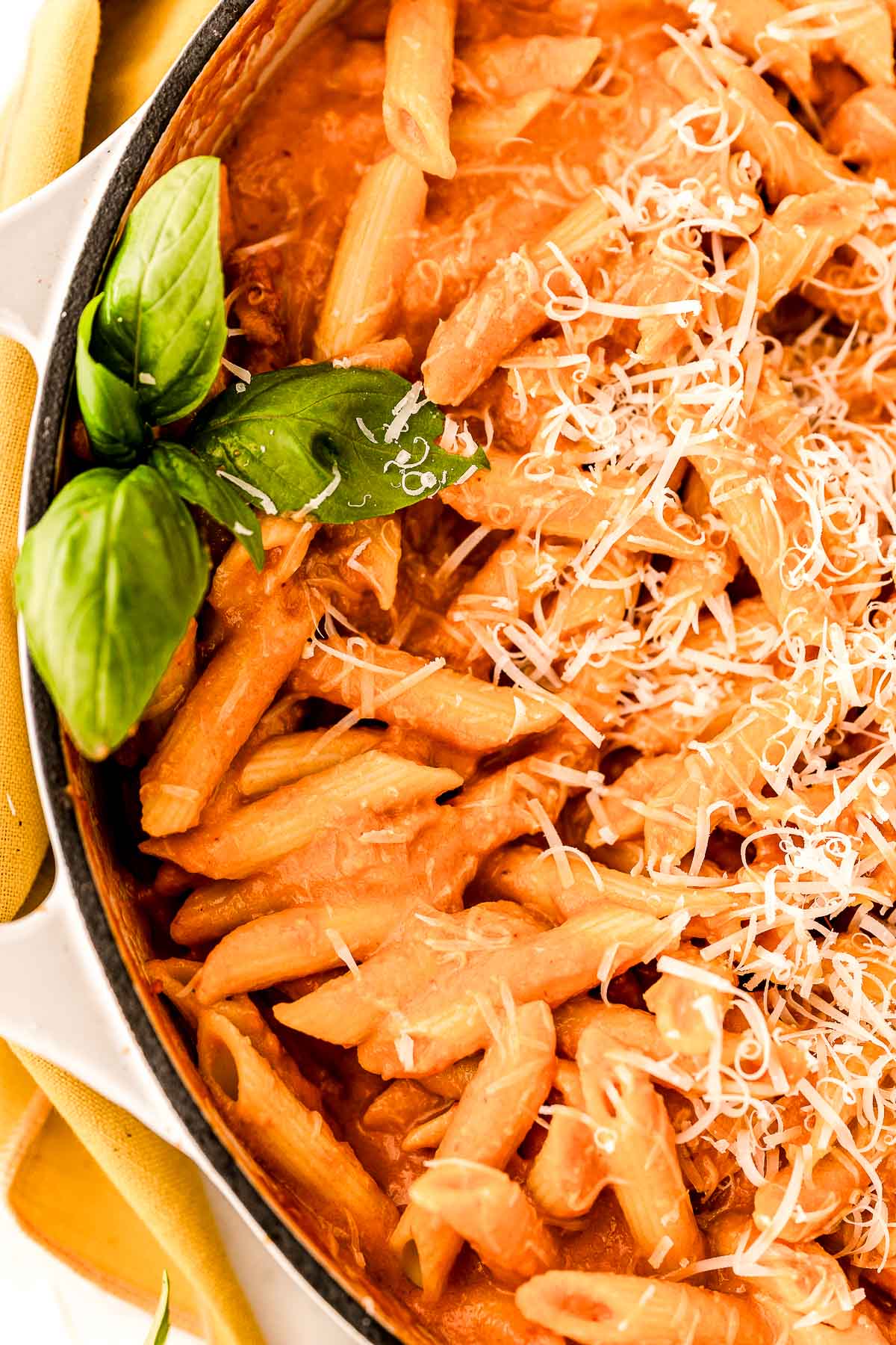 Close up photo of penne with vodka sauce in a large skillet.