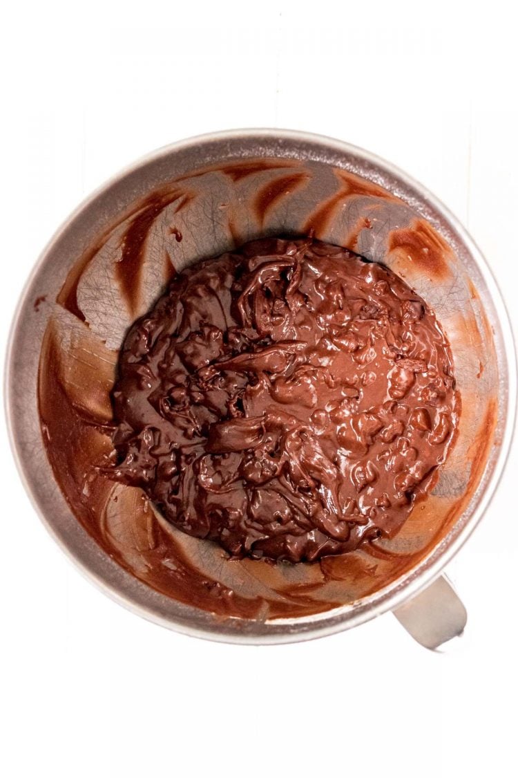 Brownie cookie dough in a metal mixing bowl.