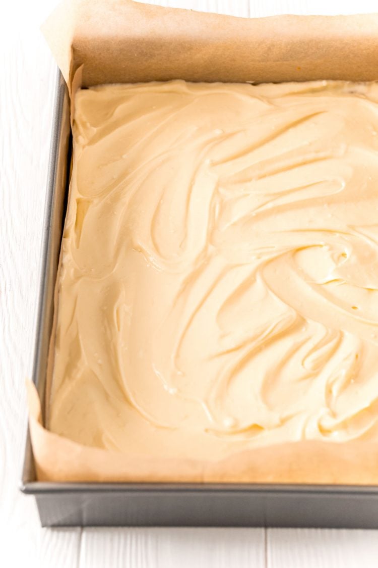 Chesecake batter in a 9x13-inch baking pan.