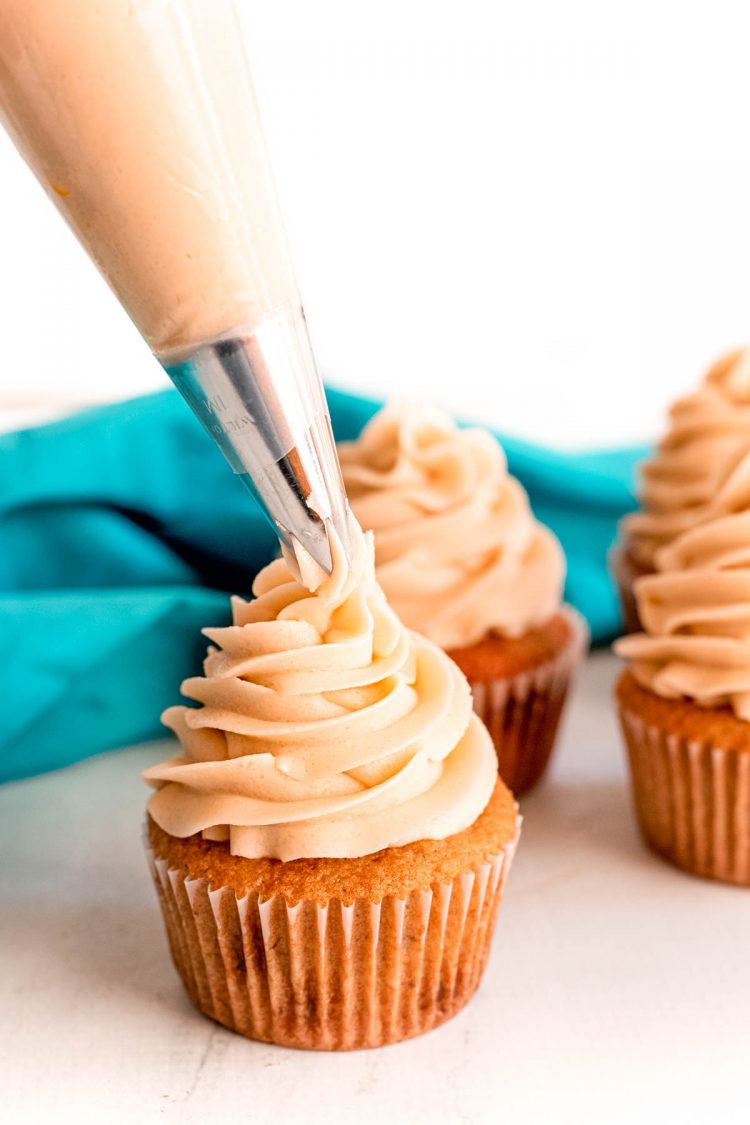 Brown Sugar Frosting being piped on a cupcake.