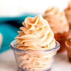 Close up photo of brown sugar frosting in a glass prep bowl.