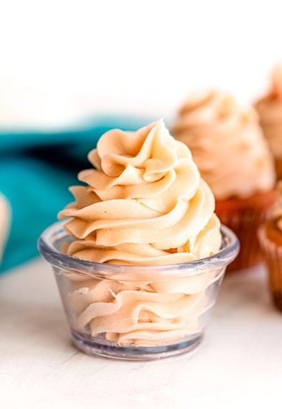 Close up photo of brown sugar frosting in a glass prep bowl.