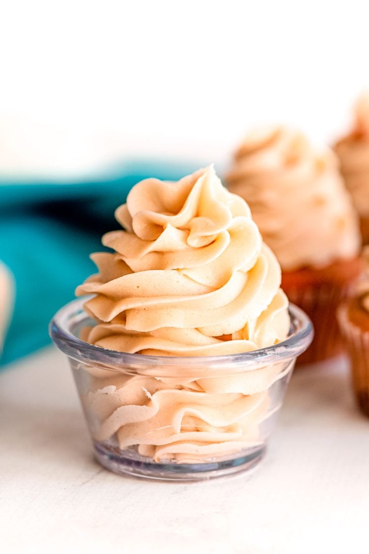 Close up photo of brown sugar frosting in a glass prep bowl.