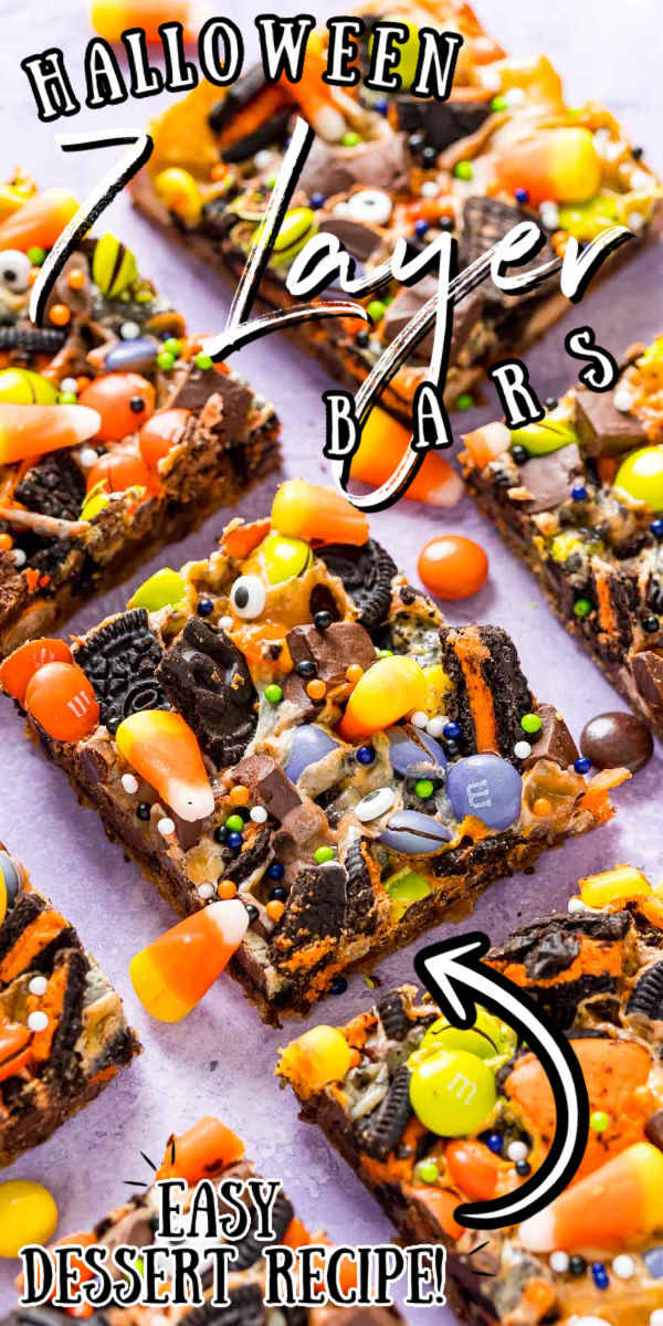 Halloween Seven Layer Bars are piled high with treats! A base of refrigerated chocolate chip cookie dough is topped with layers of Oreos, chocolate chunks, Reeses Pieces, M&Ms, and gooey sweetened condensed milk. The finishing touch is a handful of candy corn and some Halloween sprinkles! via @sugarandsoulco