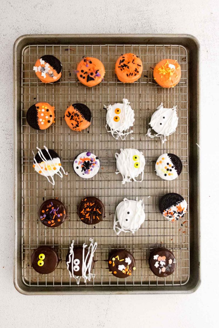 Halloween decorated Oreos on a baking sheet.