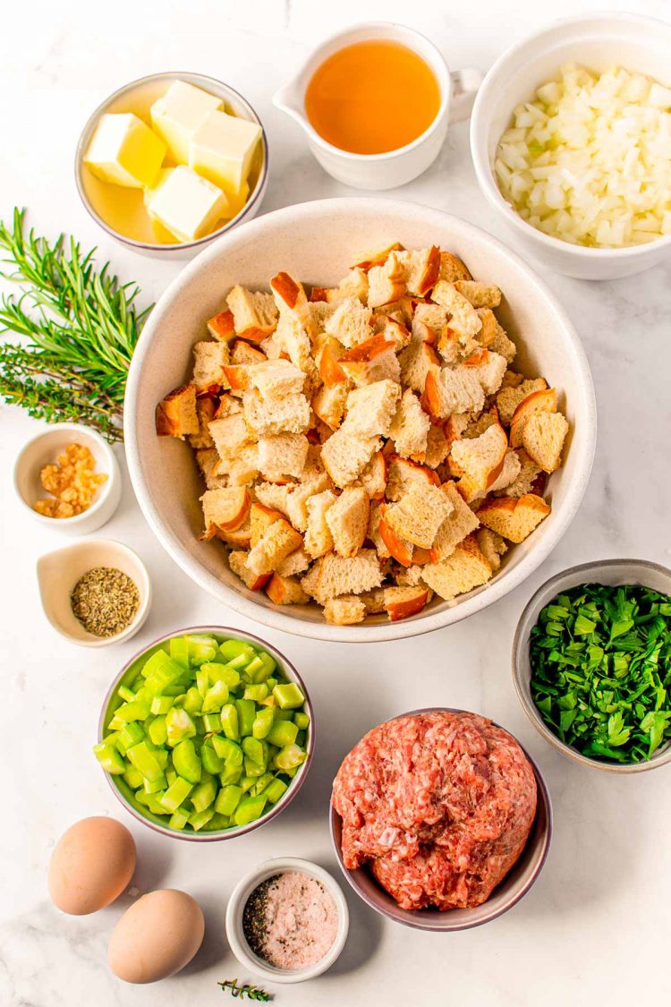 Overhead photo of ingredients to make sausage stuffing on a table.