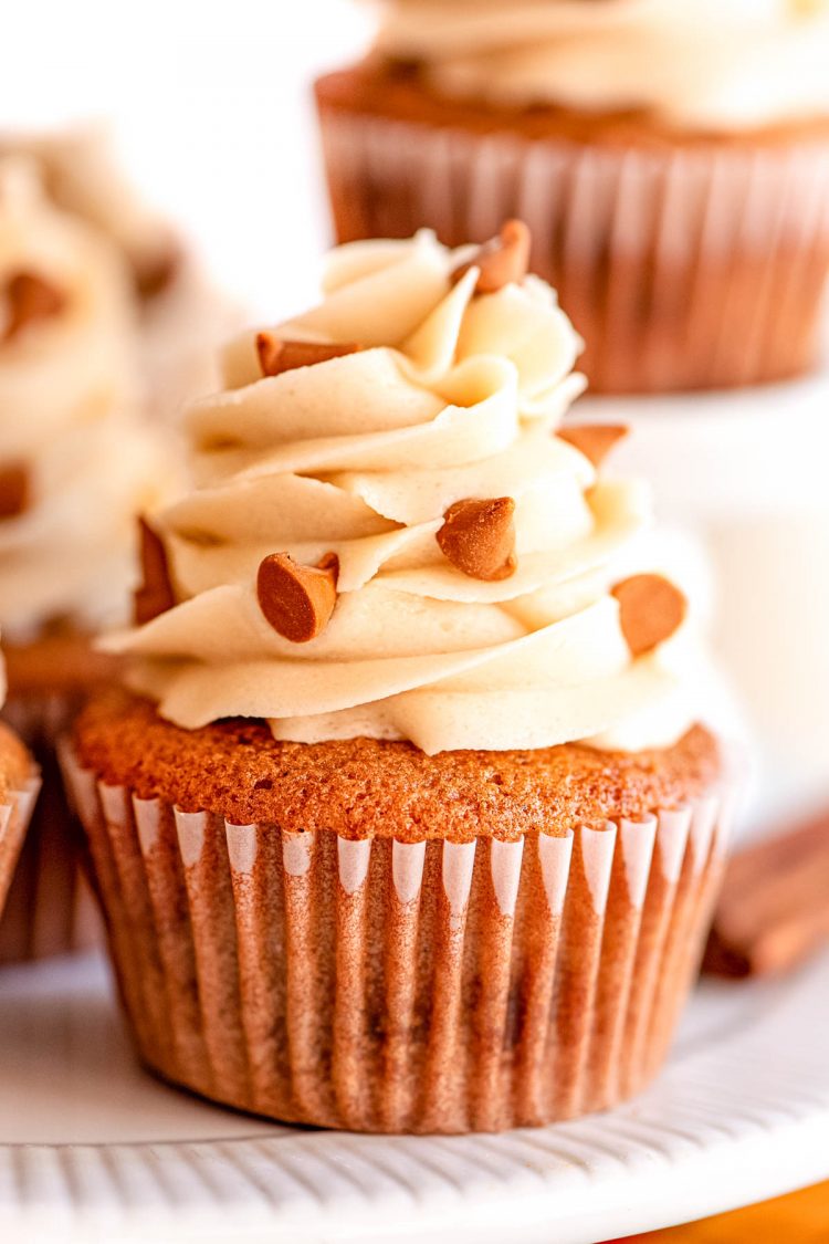 Close up photo of a cupcake on a white cake stand.