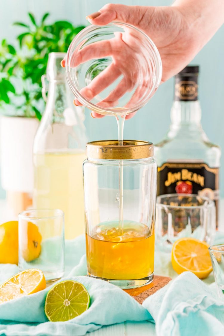 Egg white being added to a cocktail shaker.