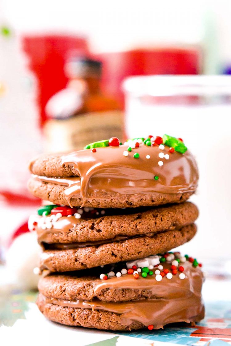 A stack of three chocolate sandwich cookies with holiday sprinkles.