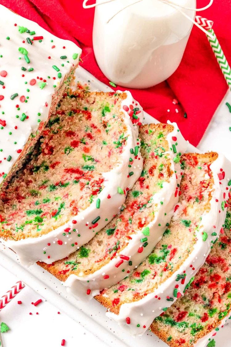 Close up of christmas quick bread sliced on a white serving tray.