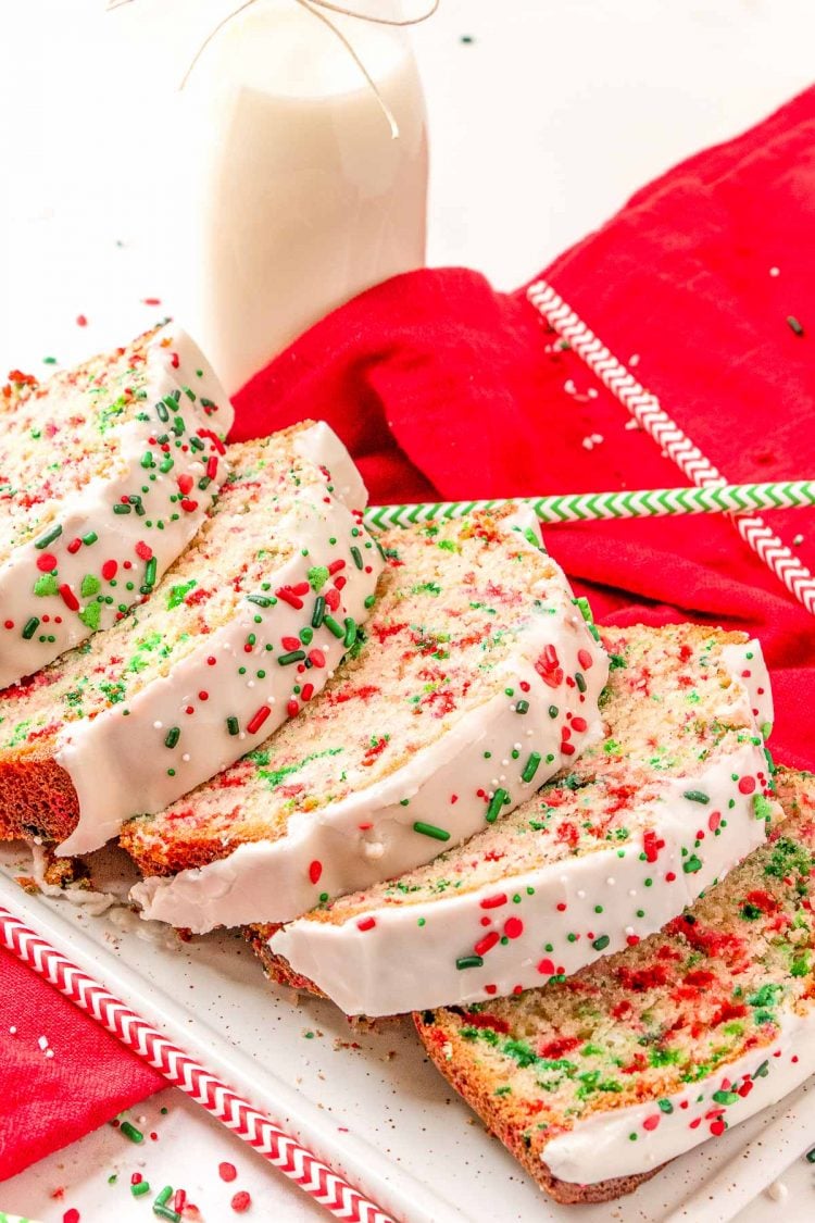 Christmas funfetti bread sliced on a white serving tray.