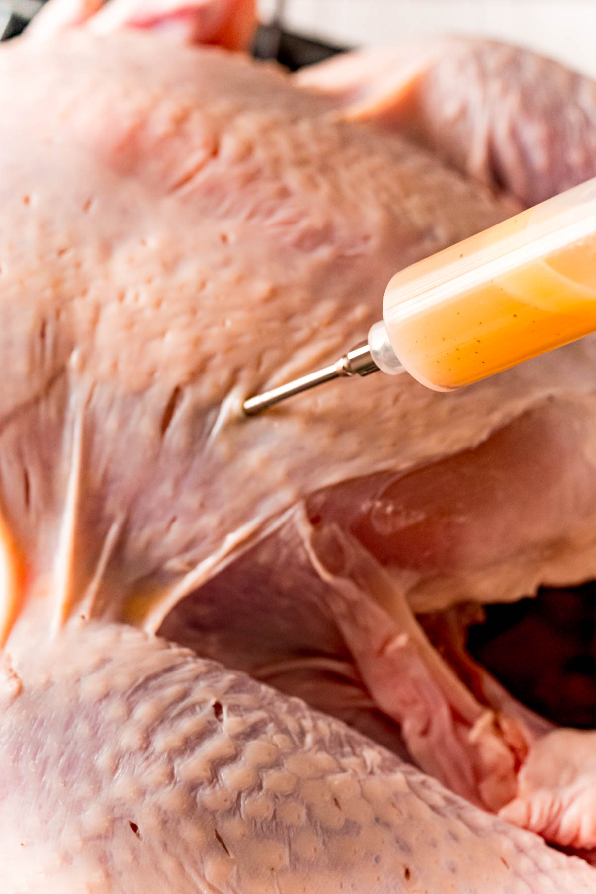 Marinade being injected into a turkey.