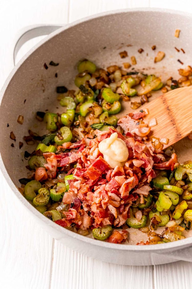 Celery, onions, bacon, and garlic in a skillet.