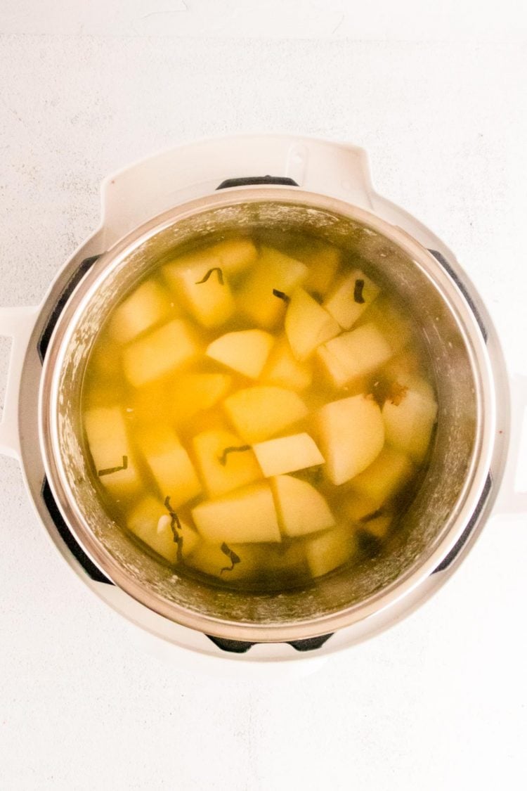 Potatoes and water in an instant pot ready to cook.