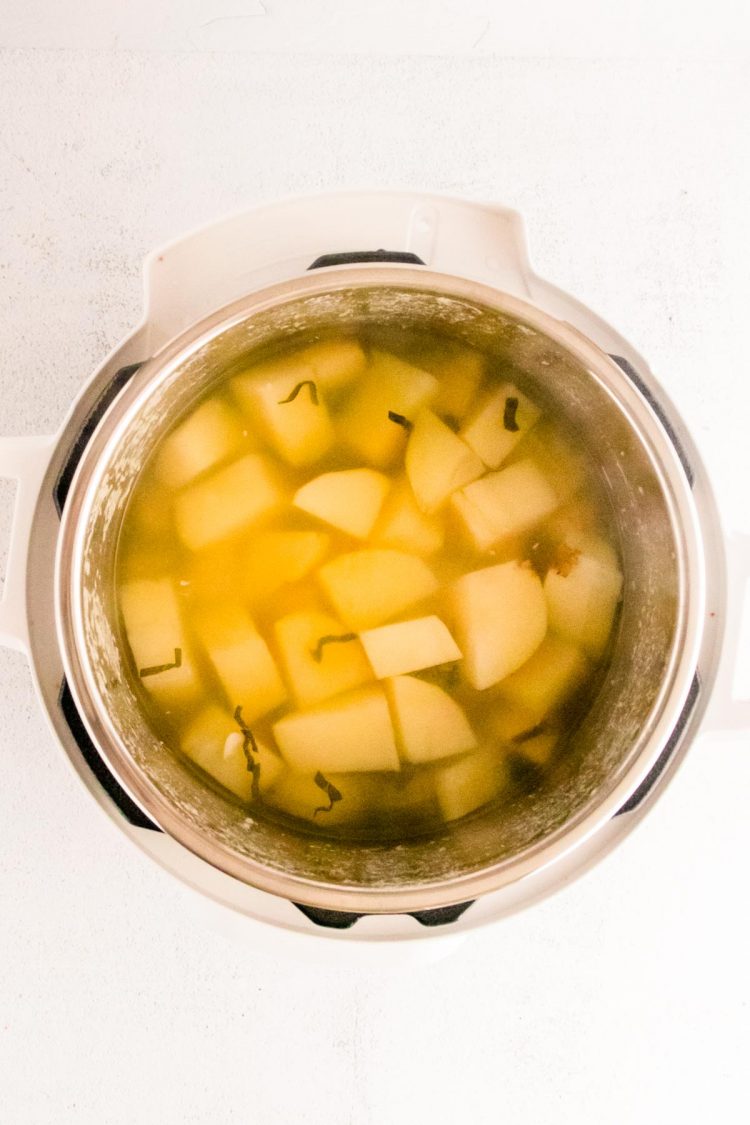 Potatoes and water in an instant pot ready to cook.