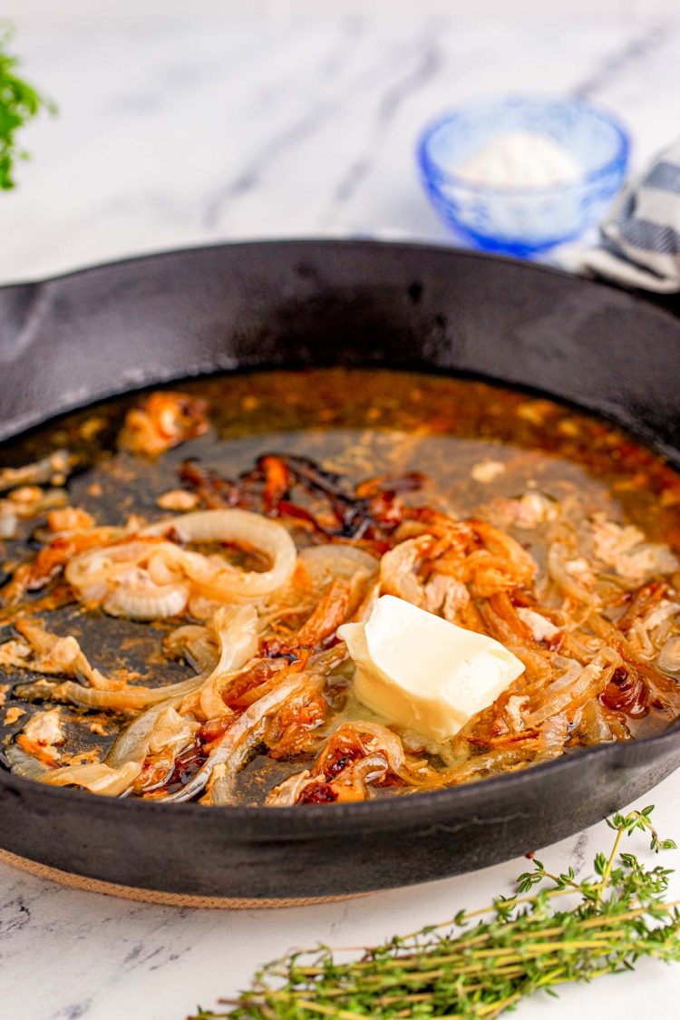 Butter and caramelized onions in a cast iron skillet.