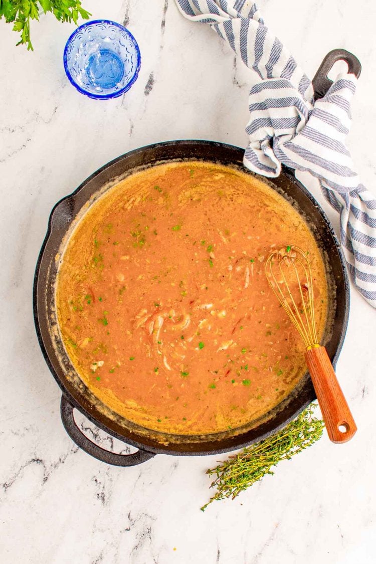 Onion gravy in a cast iron skillet.