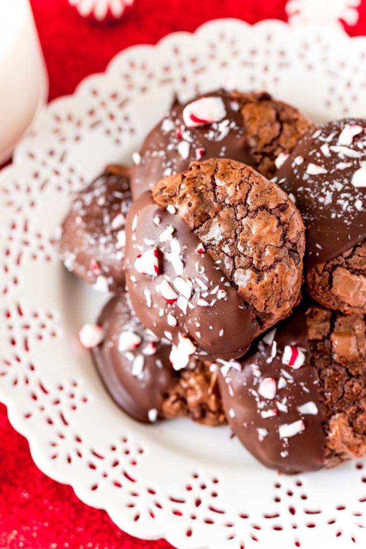 Close up photo of chocolate peppermint cookies on a white plate on a red napkin.