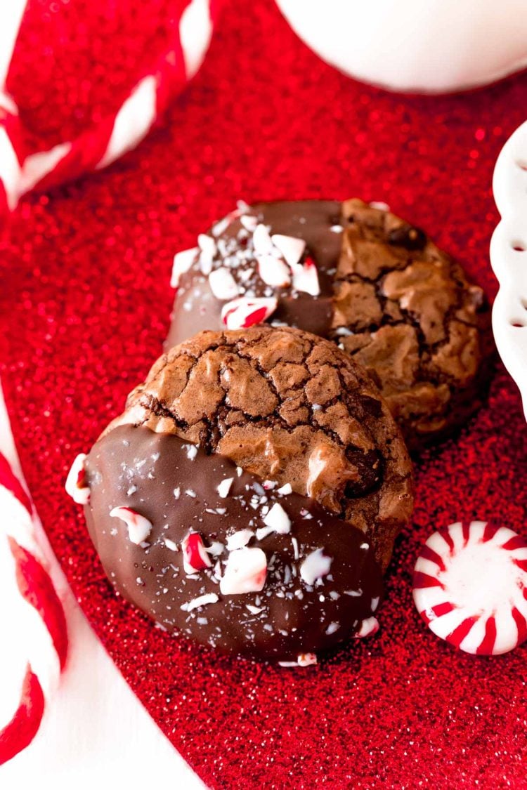 Close up photo of Peppermint brownie cookies on a red glittery surface.