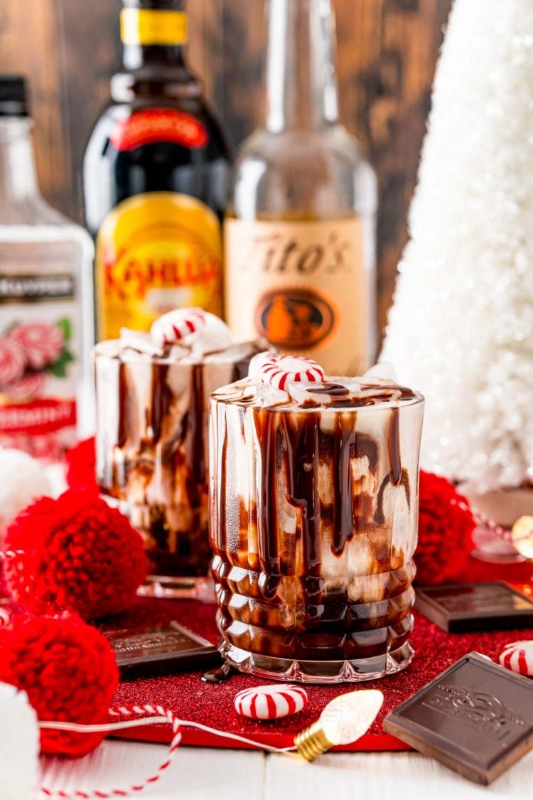 Two chocolate peppermint white russians on a table with christmas decorations.