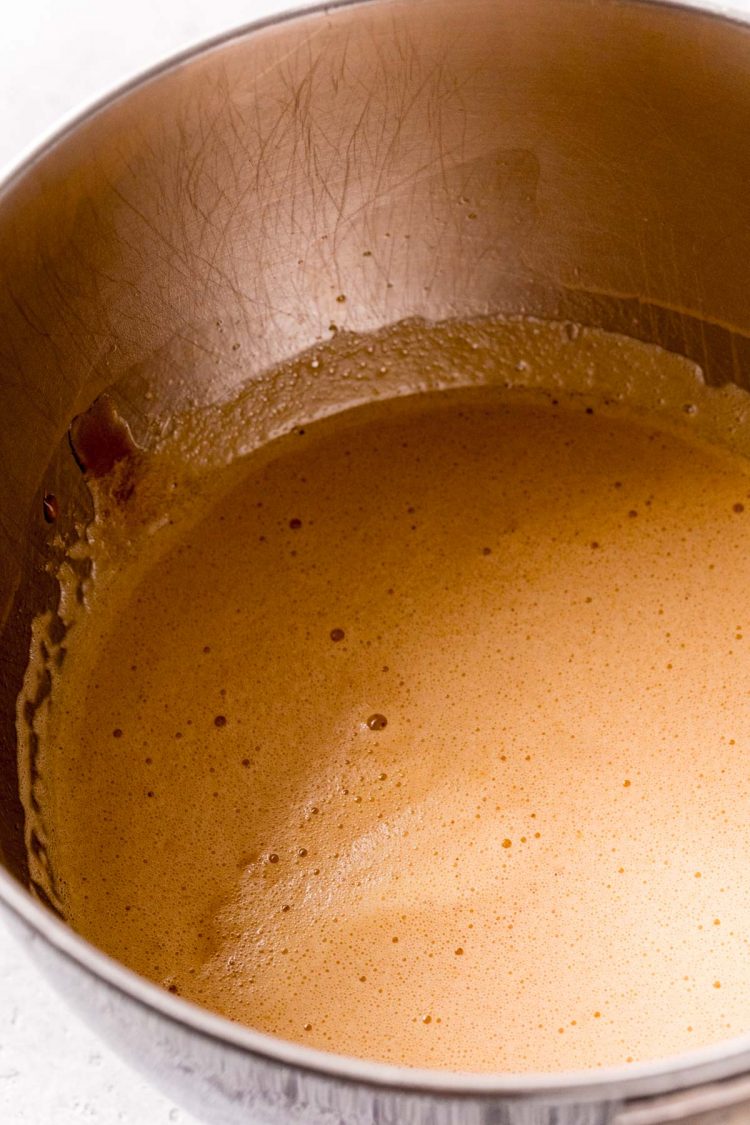 Walnut pie filling being mixed in a stainless steel mixing bowl.