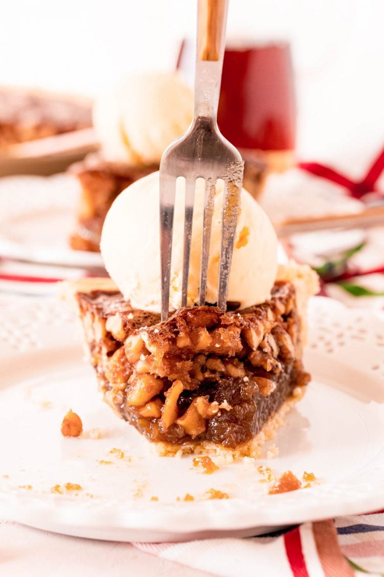 A fork taking a bite out of a walnut pie.