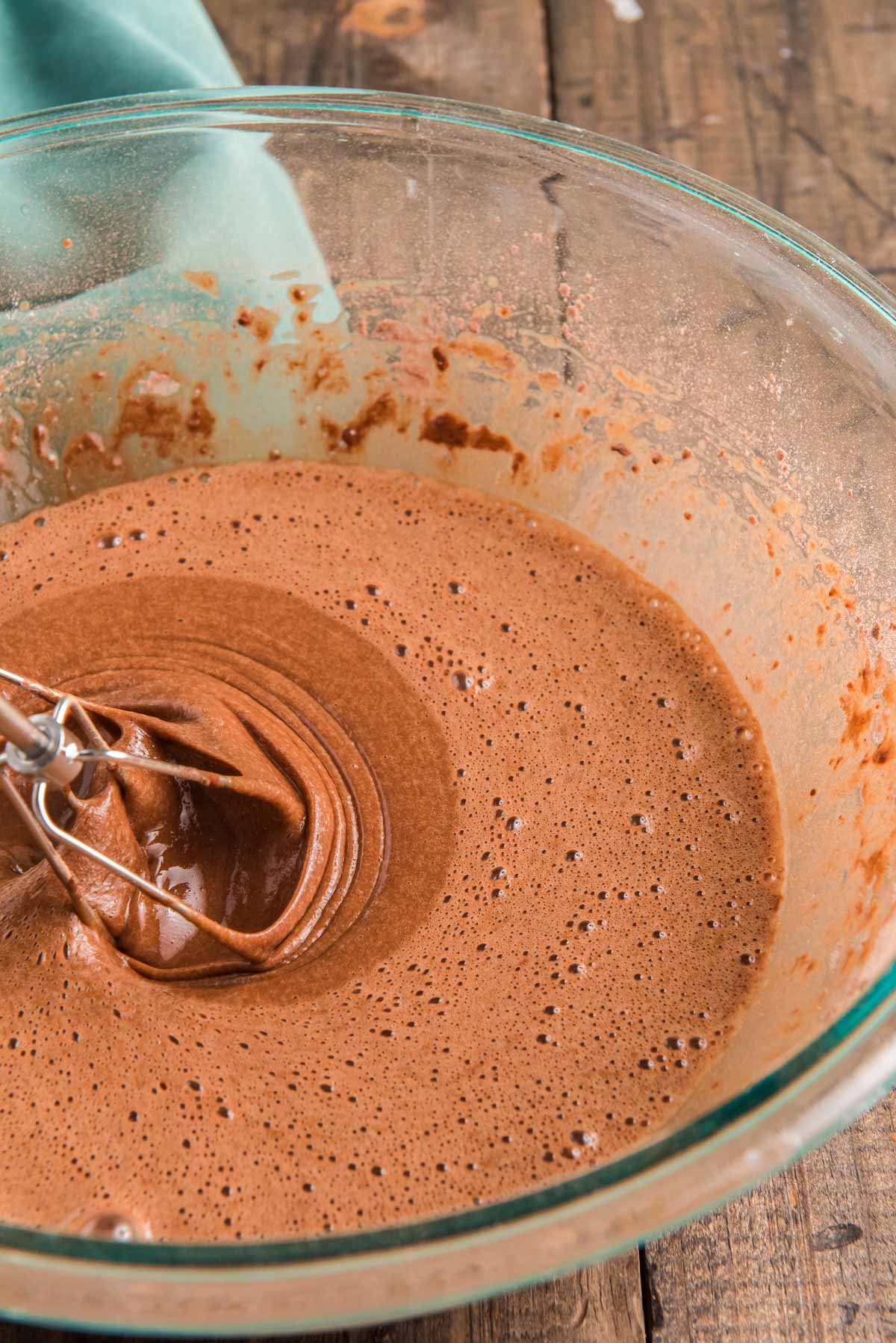 Chocolate cake batter in a glass mixing bowl.