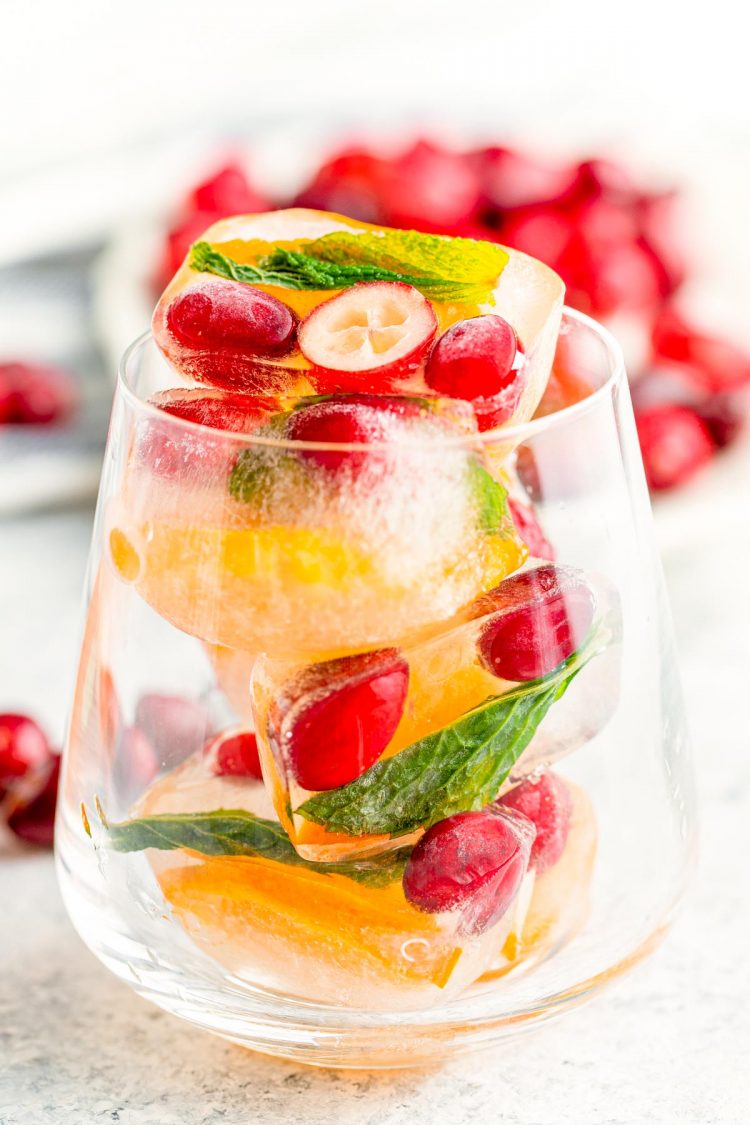 A cocktail glass filled with christmas ice cubes.