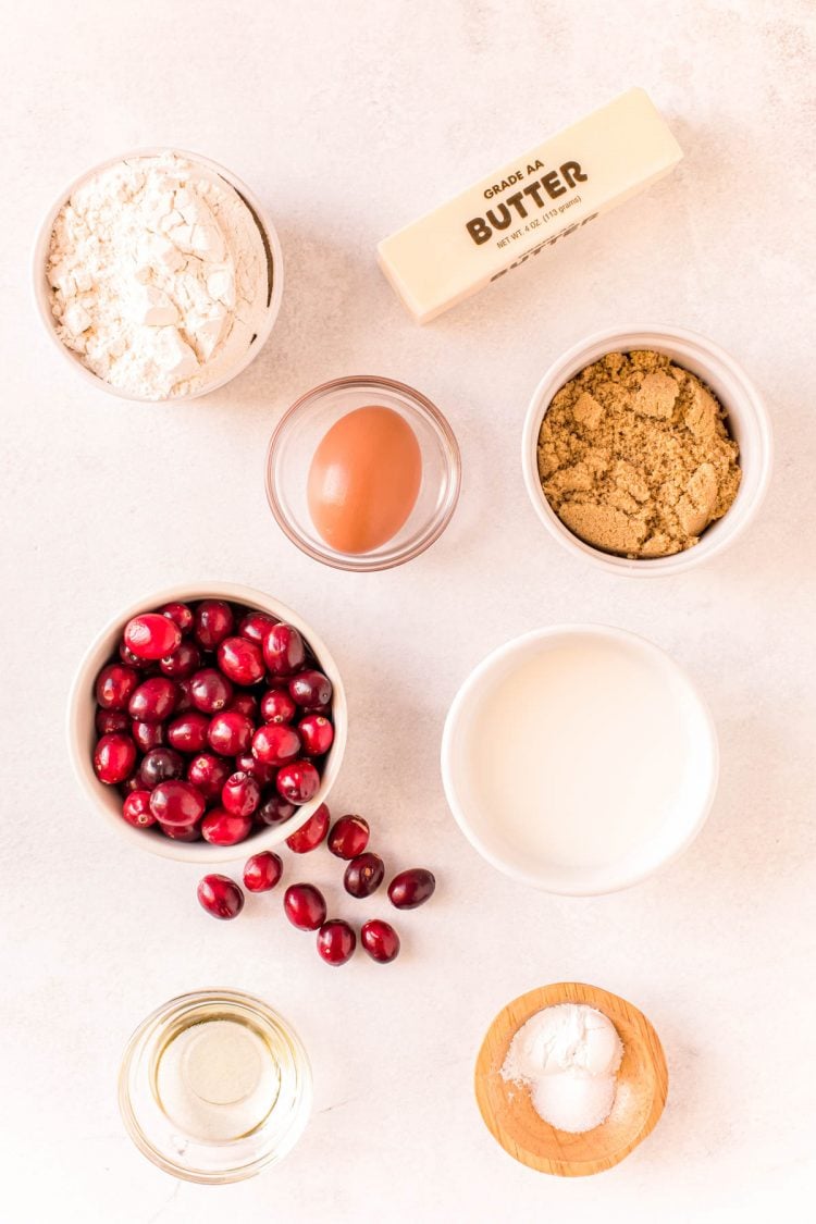 Overhead photo of ingredients to make cranberry bread on a white surface.