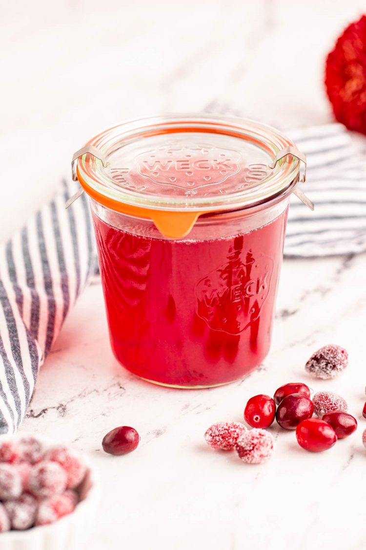 Cranberry simple syrup in a glass weck jar with the lid on.