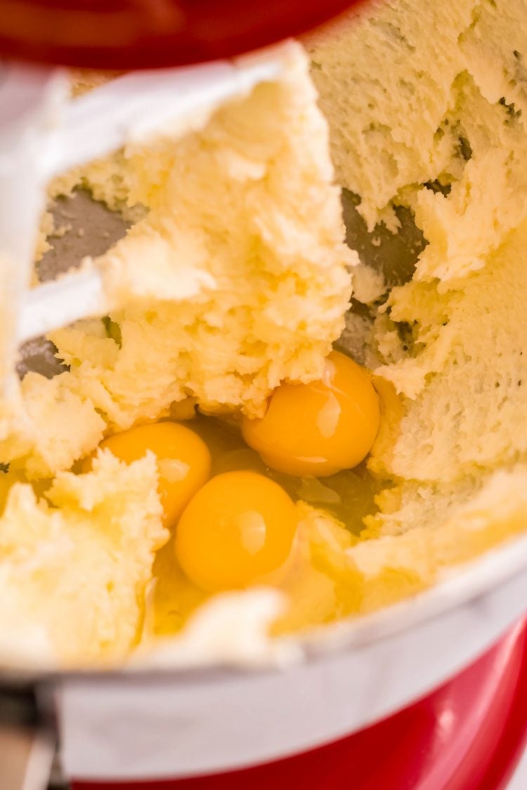 Eggs added to creamed butter and sugar in a stand mixer.