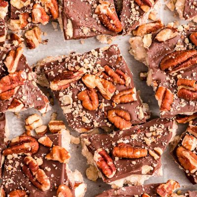 Close up photo of almond butter toffee on a baking sheet cracked up.