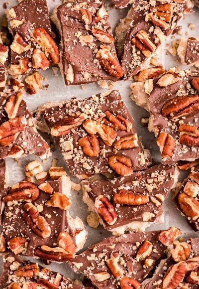 Close up photo of almond butter toffee on a baking sheet cracked up.