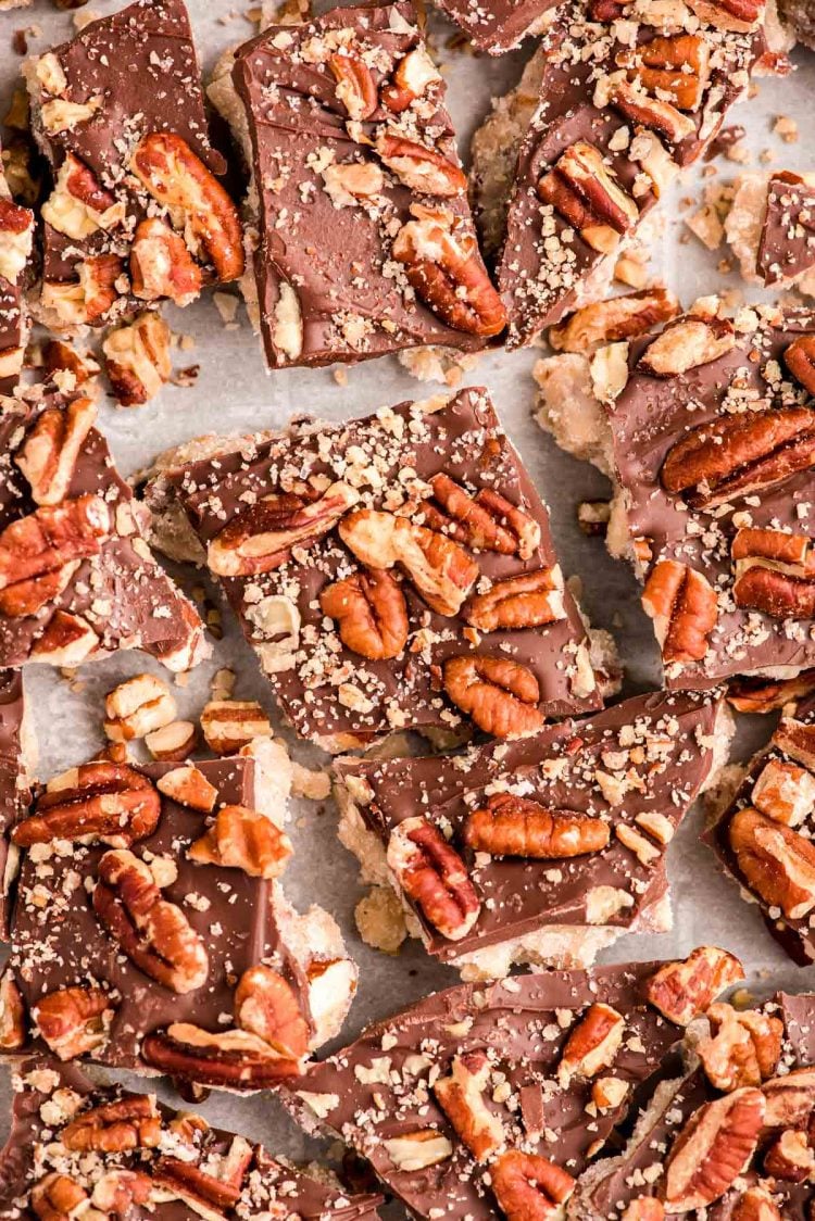 Close up photo of almond butter toffee on a baking sheet cracked up.